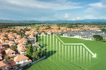 Fotobehang Land, landscape or green field in aerial view. Include house building, bar chart or graph, drop down arrow. Real estate or property with concept for sale price, land value to decrease, reduction, low. © DifferR