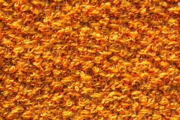 Woven yellow wool fabric texture. Hand knitted textile canvas background. Patchwork carpet backdrop. Factory material threads. Abstract design. Close-up, mockup, top view