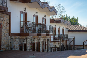 Close-up of an ancient stone building with a wooden balcony and windows