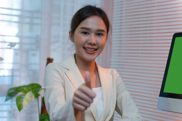 Asian businesswoman thumbs up at the home office.