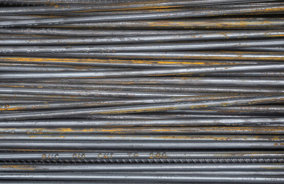 Pile of steel rods with rust used in construction