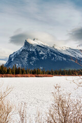 Frozen Vermillion Lake with Mount Rundle and snow covered in winter on sunny day at Banff national park