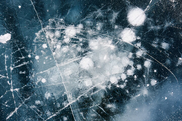 Natural ice bubbles on frozen lake in wintertime
