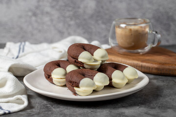 Cocoa and white chocolate cookies. Delicious cookies on dark background