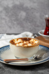 Rice pudding. Traditional Turkish cuisine desserts. Rice pudding dessert made with milk, sugar and rice on a dark background. Close up