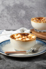 Rice pudding. Traditional Turkish cuisine desserts. Rice pudding dessert made with milk, sugar and rice on a dark background