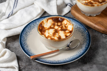 Rice pudding. Traditional Turkish cuisine desserts. Rice pudding dessert made with milk, sugar and rice on a dark background