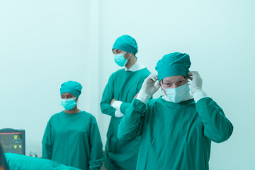 Fototapeta na wymiar Portrait of professor of medicine in cardiology and a team of doctors in the operating room undergoing heart transplant surgery