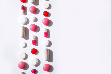 Assorted of colorful tablets, capsules, pills, vitamins on white background. Medicine drug concept, minimalist mockup. Pharmaceutical health care background Flat lay top view copy space