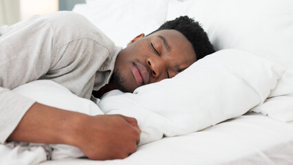 Sleep, relax and dream for a black man home in bed on a weekend morning. Tired, sleeping and...