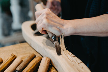 photographs of a woman engaged in hand-carving