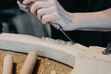 photographs of a woman engaged in hand-carving