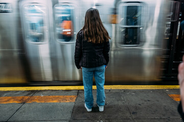Teen girl waiting for subway train