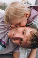 Dad and baby daughter have fun near the football field stadium
