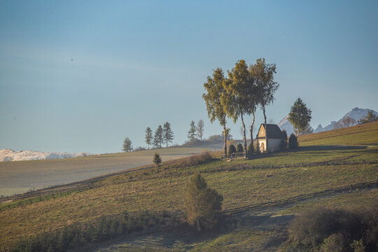Landscape with a chapel and snow-covered Tatra Mountains in Kacwin, Malopolskie, Poland