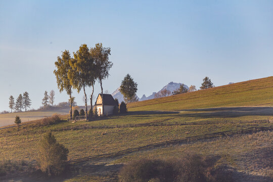 Landscape with a chapel and snow-covered Tatra Mountains in Kacwin, Malopolskie, Poland