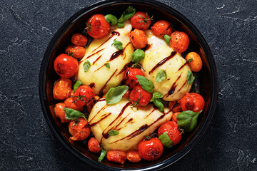 caprese chicken in black baking dish, top view