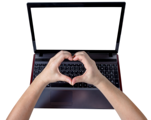 Woman hands making a heart shape on laptop isolated