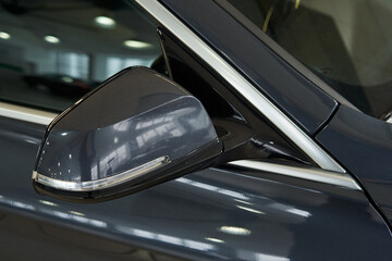 gray car side mirror with turn signal repeater