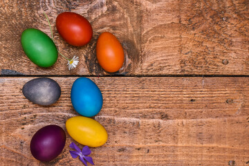 Obraz na płótnie Canvas Traditional painted Easter eggs on wooden background. Colorful background of Easter eggs collection, Easter celebration