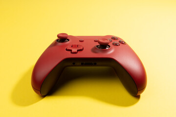 red game controller isolated on yellow background