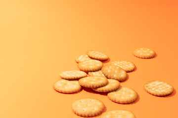 Cookies on orange background. Artistic background for pastry or sweet snacks