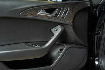 Obraz na płótnie Canvas premium car door trim with built-in speakers door lock and unlock buttons, handles, mirror adjustments, seat position memory buttons