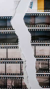 35mm filmstrips printed on white torn copy paper, cool cover or poster idea, empty or blank film material.	9:16 content.