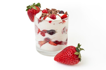 Strawberries, forest fruits and whipped cream in a transparent glass