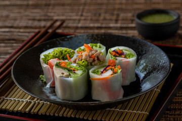 Rolled flat rice noodles, Lui Suan noodles, with assorted stuffs like minced pork, carrot, imitation crab stick, sausage, lettuce, cabbage. It is an easy lean-healthy Thai food dish.