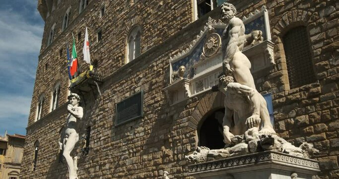 David. Michelangelo's David and Hercules and Cacus.Sculptures in front of the Palazzo Vecchio in Florence on the Piazza della Signoria. 
