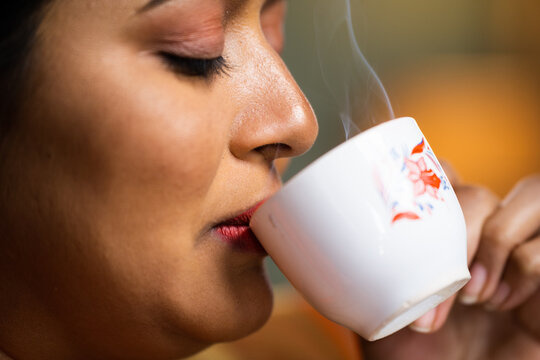 Extreme Close Up Shot Of Happy Woman Enjoys Drinking Tea Or Coffee During Early Morning - Concept Of Refreshment, Calmness And Tranquility