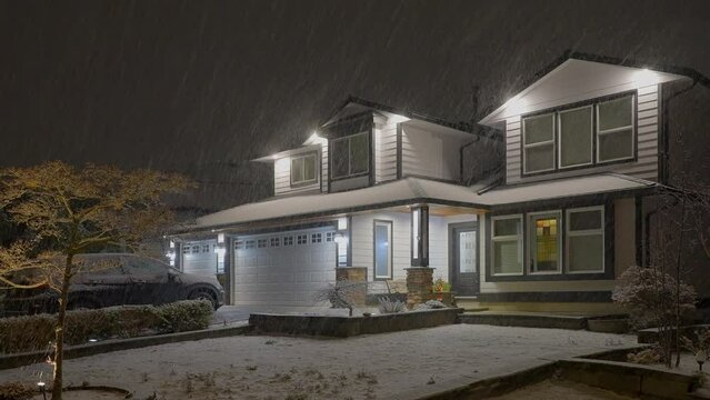 Establishing shot of luxury house with nice landscape at winter snowfall at night in Vancouver, Canada, North America. Night time on December 2021. ProRes 422 HQ.