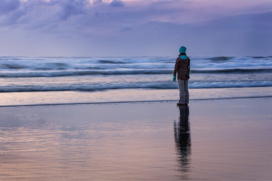 A Person Looking Towards The Horizon At Sunset