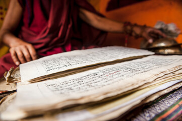 A monk with buddhist scriptures in Hemis monastery, Ladakh, India.