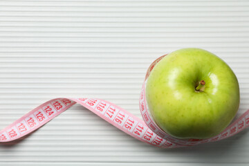 Diet and weight loss, healthy lifestyle, composition with measuring tape, space for text