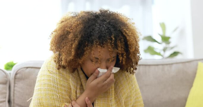 Allergy, sick and woman blowing nose with tissue for covid, cold and sneezing on the sofa. Bad, sinusitis and girl on the living room couch with corona, flu or a virus while in quarantine at home