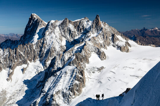 Alpine Climbers Making Their Way Along A Ridge Just Below The Aiguille Du Midi