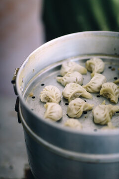 Momos (chicken dumplings) sit in a Nepali steamer.