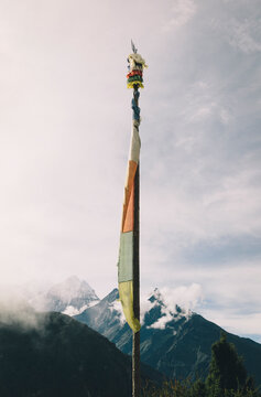 A prayer flag stands tall in the Everest Region in monsoon season in Nepal.