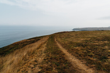 Cliffs surrounding the Beach of Antuerta in Ajo, Trasmiera, Cantabria, Spain. The coast is traversed by a hiking trail that runs through stunning scenery.