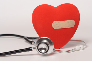 red heart with a band-aid and a stethoscope