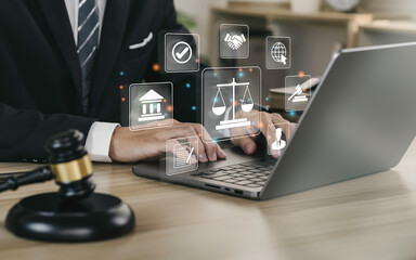 Hand of the businessman or  Lawyer with legal services icon on the laptop screen for Legal advice online in Labor law for a business company legal. concept of legal consultant and lawyer - obrazy, fototapety, plakaty