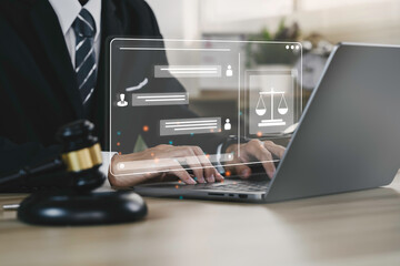 Hand of the businessman or  Lawyer with legal services icon on the laptop screen for Legal advice...