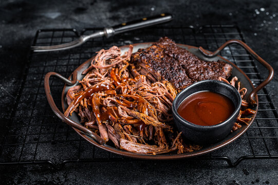 Slow Cooked Pulled Beef, Traditional meat rubbed with spices and smoked in a Texas smoker. Black background. Top view