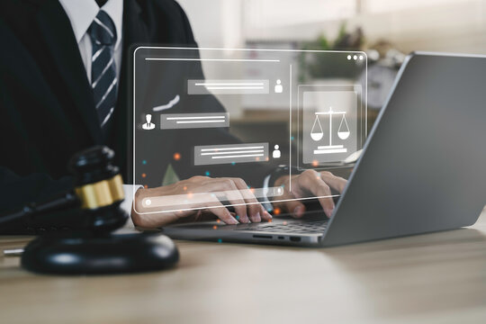 Hand of the businessman or  Lawyer with legal services icon on the laptop screen for Legal advice online in Labor law for a business company legal. concept of legal consultant and lawyer