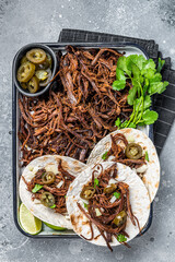Cooking of Mexican lamb Barbacoa Tacos with Cilantro and Onion. Gray background. Top view