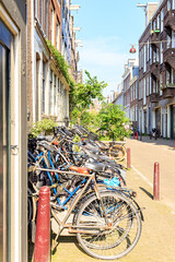 Fototapeta na wymiar Amsterdam, Netherlands - June 30, 2019: The historic city center of Amsterdam in the morning. Tweede Weteringdwarsstraat Street