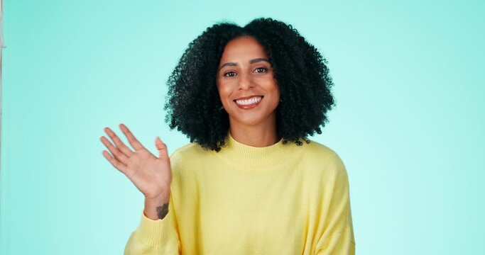 Portrait, wave and greeting with a black woman in studio on a blue background to say hello or welcome. Hand gesture, waving or friendly and an attractive young female saying goodbye with a smile