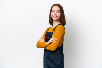 Young Ukrainian woman isolated on white background with arms crossed and happy